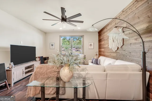 a view of swimming pool with lounge chair and dinning table under an umbrella