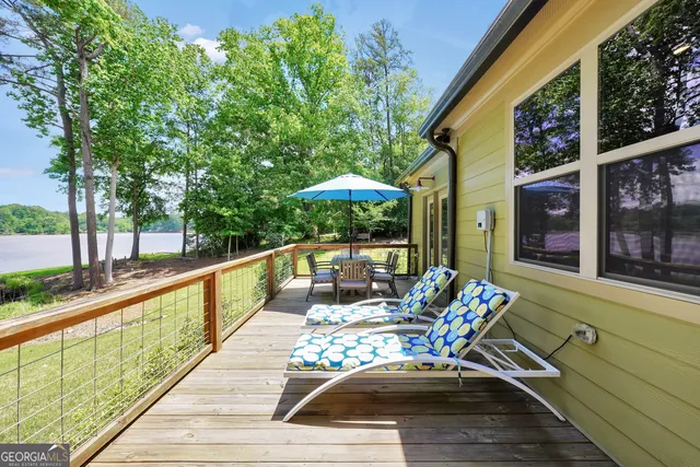 a view of a swimming pool with outdoor seating and yard