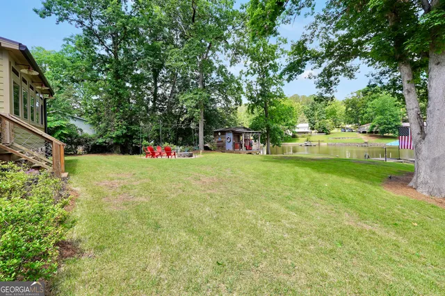 a backyard of a house with table and chairs