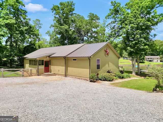 a kitchen with stainless steel appliances granite countertop a refrigerator a sink dishwasher and a stove with wooden floor