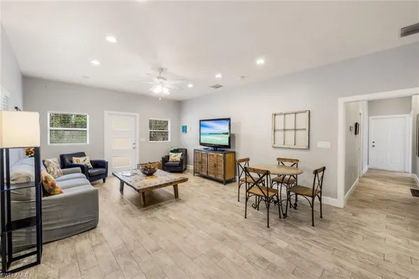 a living room with furniture and a wooden floor