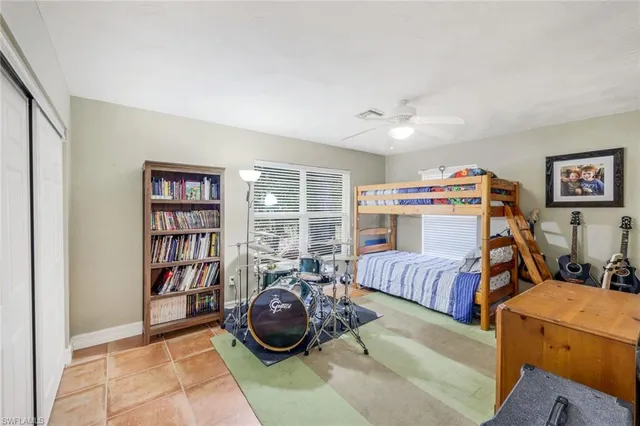 a bedroom with furniture and a book shelf