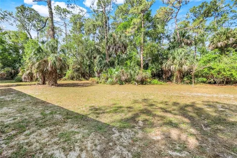 a backyard of a house with table and chairs