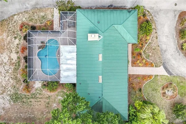 an aerial view of a house with a yard