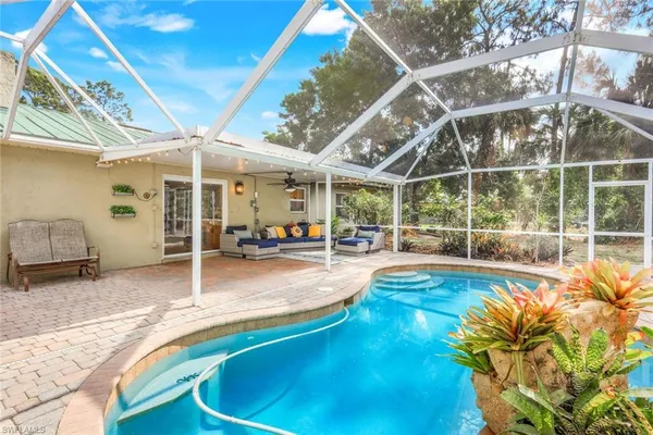 a view of a swimming pool with a patio and a yard