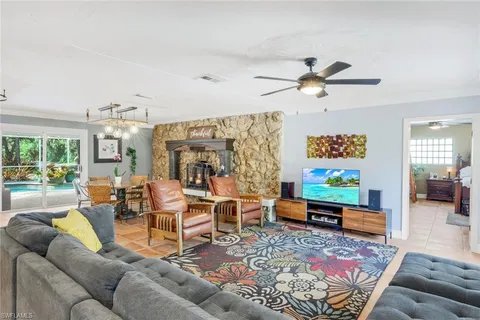 a living room with furniture ceiling fan and a rug