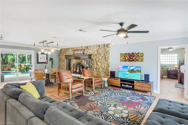 a living room with furniture ceiling fan and a rug