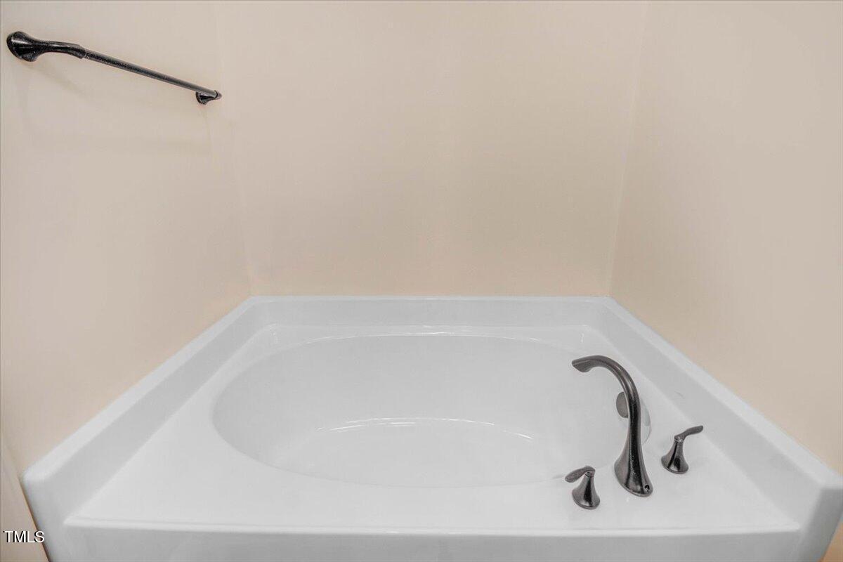 736 Wickham Ridge Road Apex, NC 27539 - Photo 25 of 41 a close view of a bathtub in bathroom