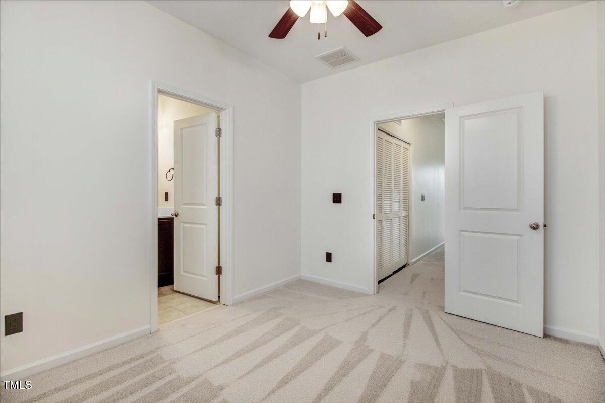 736 Wickham Ridge Road Apex, NC 27539 - Photo 28 of 41 an empty room with fan and entrance