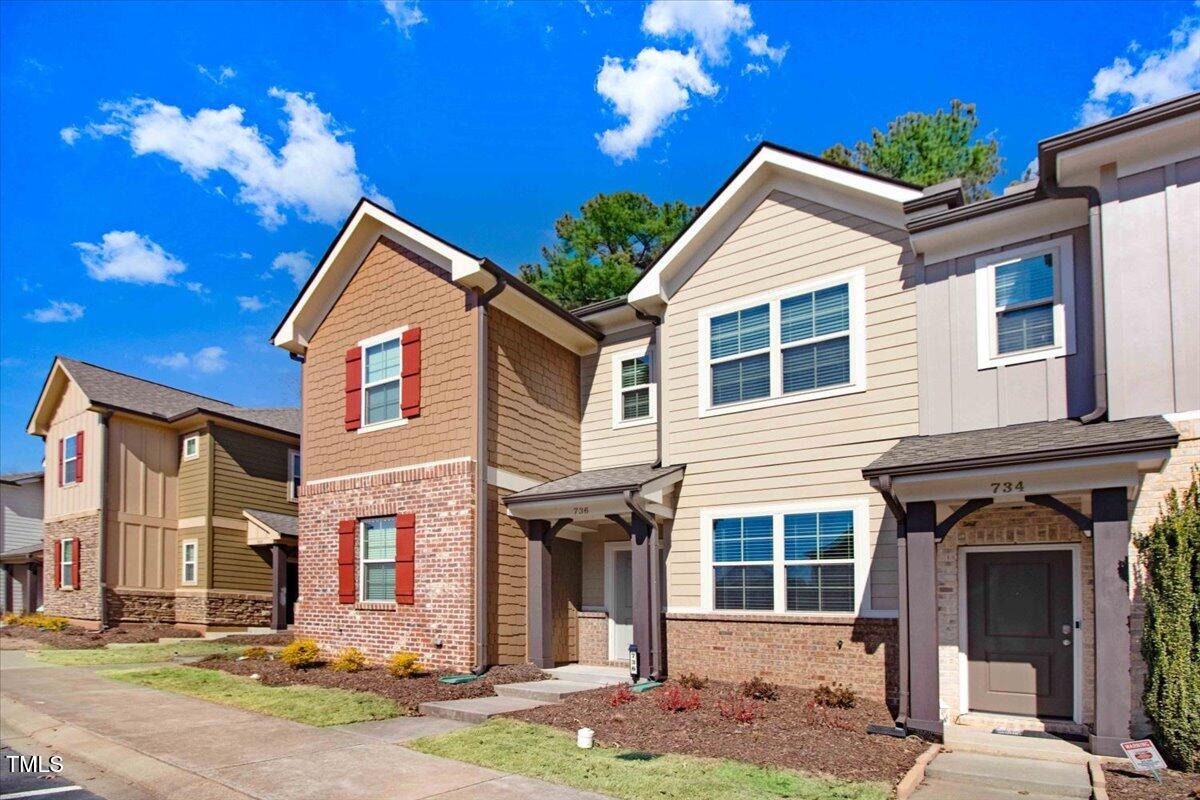 736 Wickham Ridge Road Apex, NC 27539 - Photo 3 of 41 a front view of a house with a yard