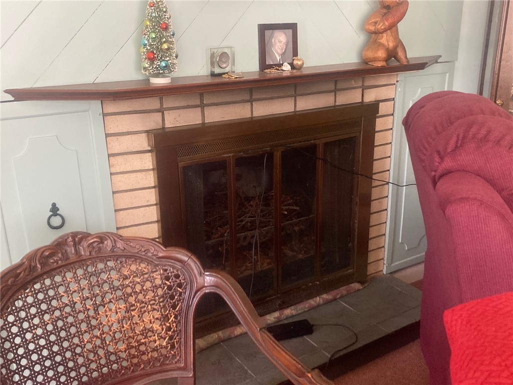 25 Oakridge Road Scituate, RI 02857 - Photo 11 of 16 livingroom is drenched with natural light and has a cozy fireplace