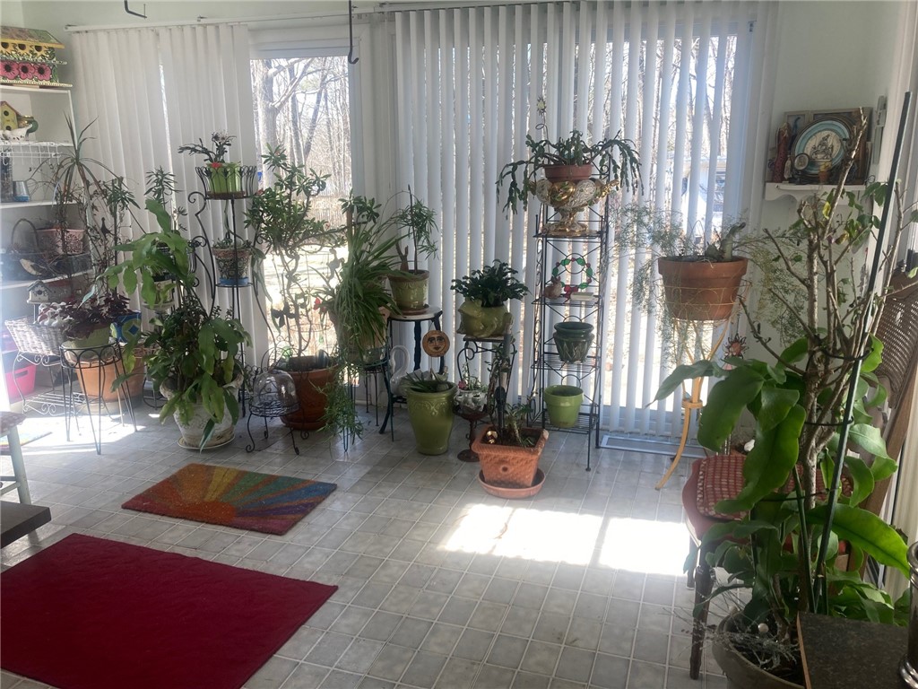 25 Oakridge Road Scituate, RI 02857 - Photo 4 of 16 air condition sunroom with multiple sliders out to backyard