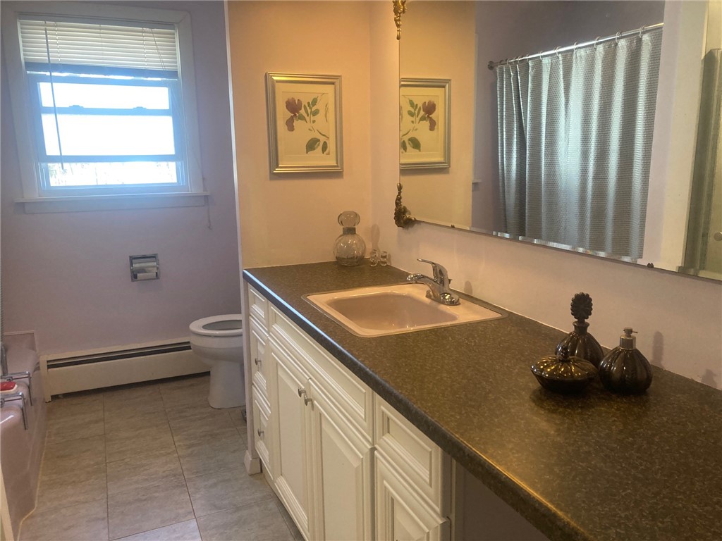 25 Oakridge Road Scituate, RI 02857 - Photo 8 of 16 newer cabinetry and all appliances remain in tiled kitchen