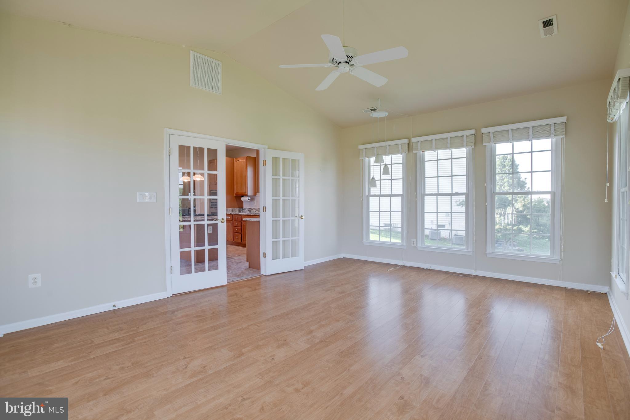 14308 South Hall Court Culpeper, VA 22701 - Photo 18 of 78 a view of an empty room with a window and wooden floor