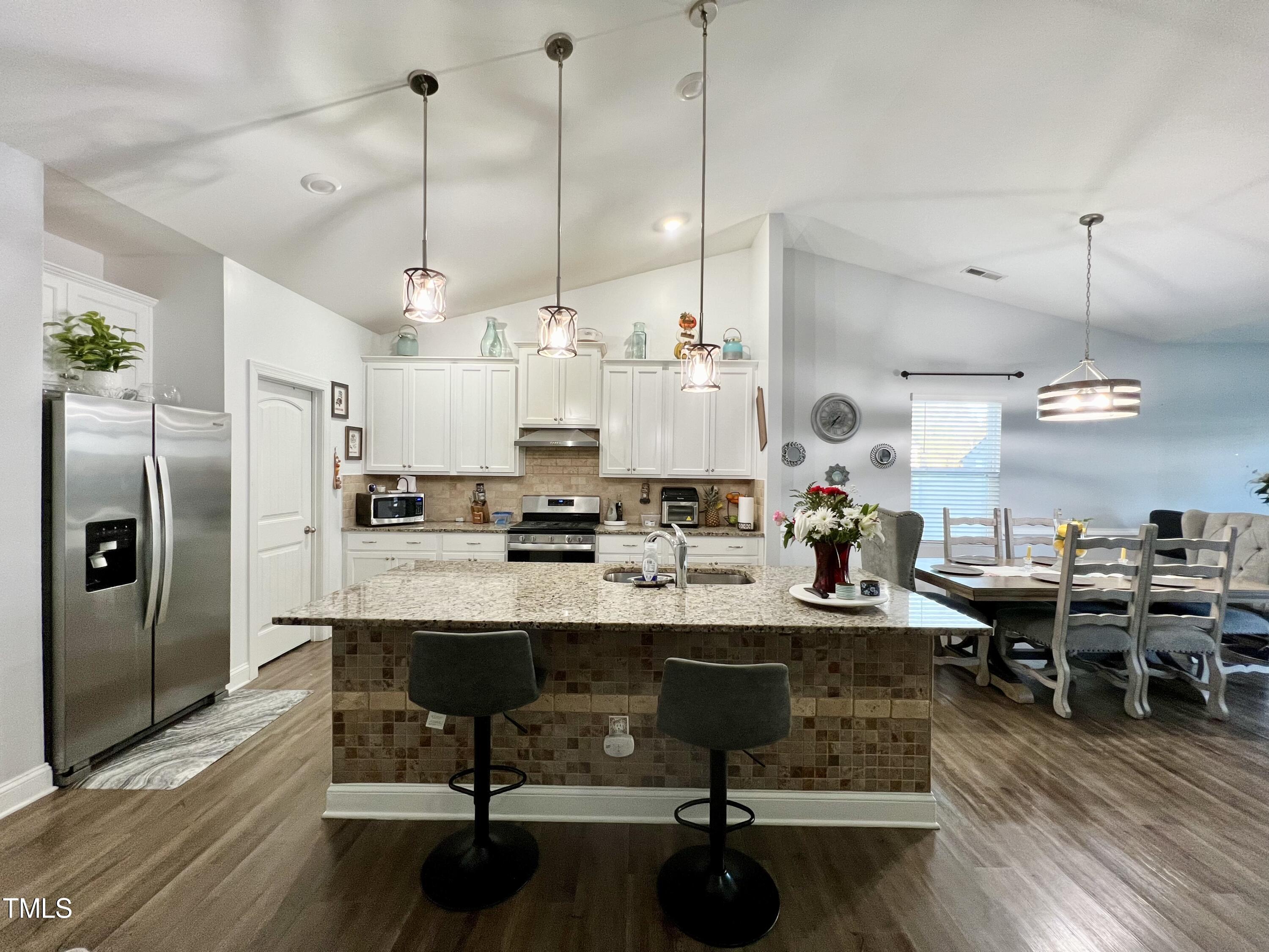 5313 Rovan Way Raleigh, NC 27604 - Photo 6 of 21 a room with lots of wooden furniture and a chandelier