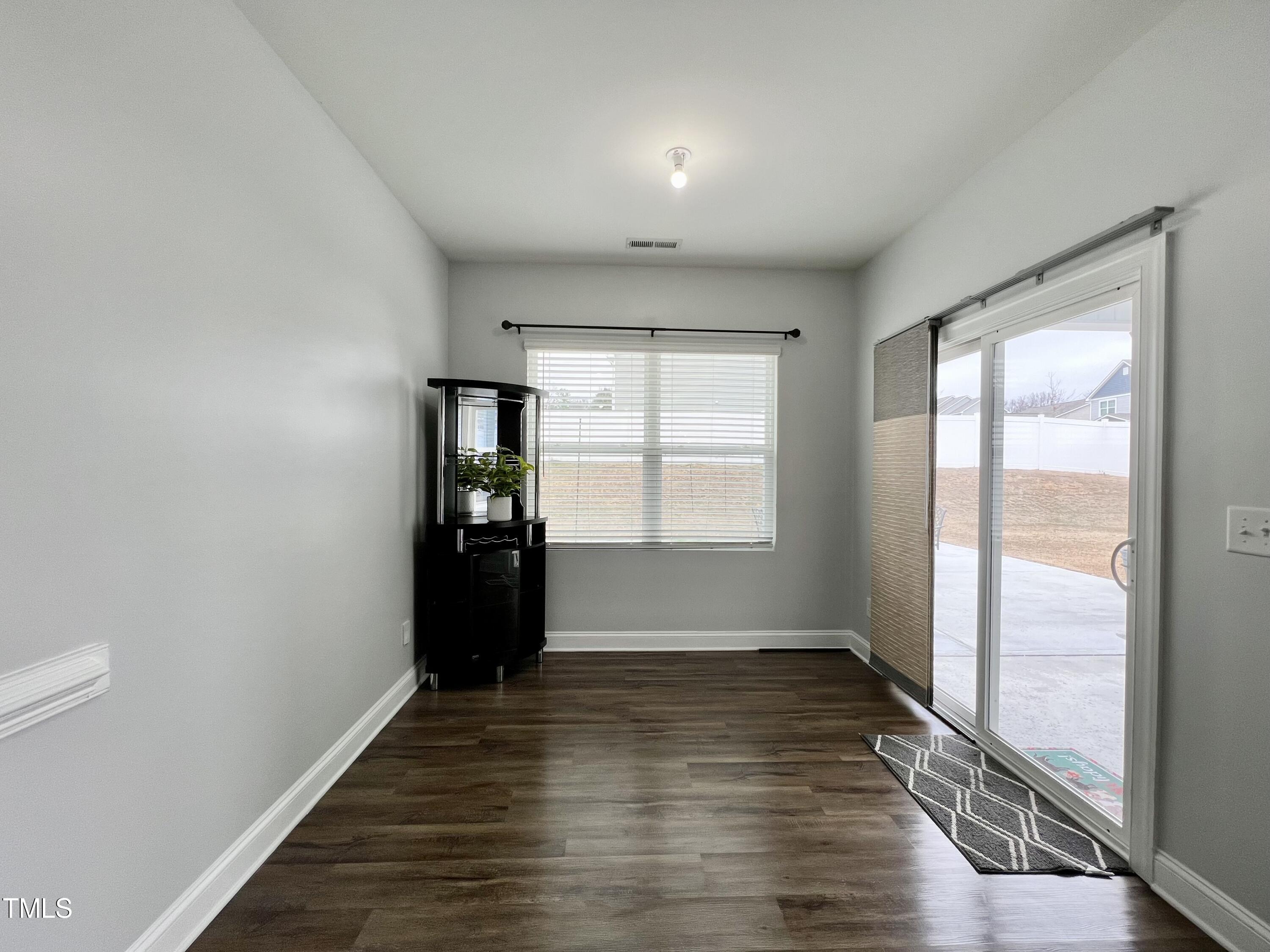 5313 Rovan Way Raleigh, NC 27604 - Photo 8 of 21 a view of an empty room with wooden floor and a window