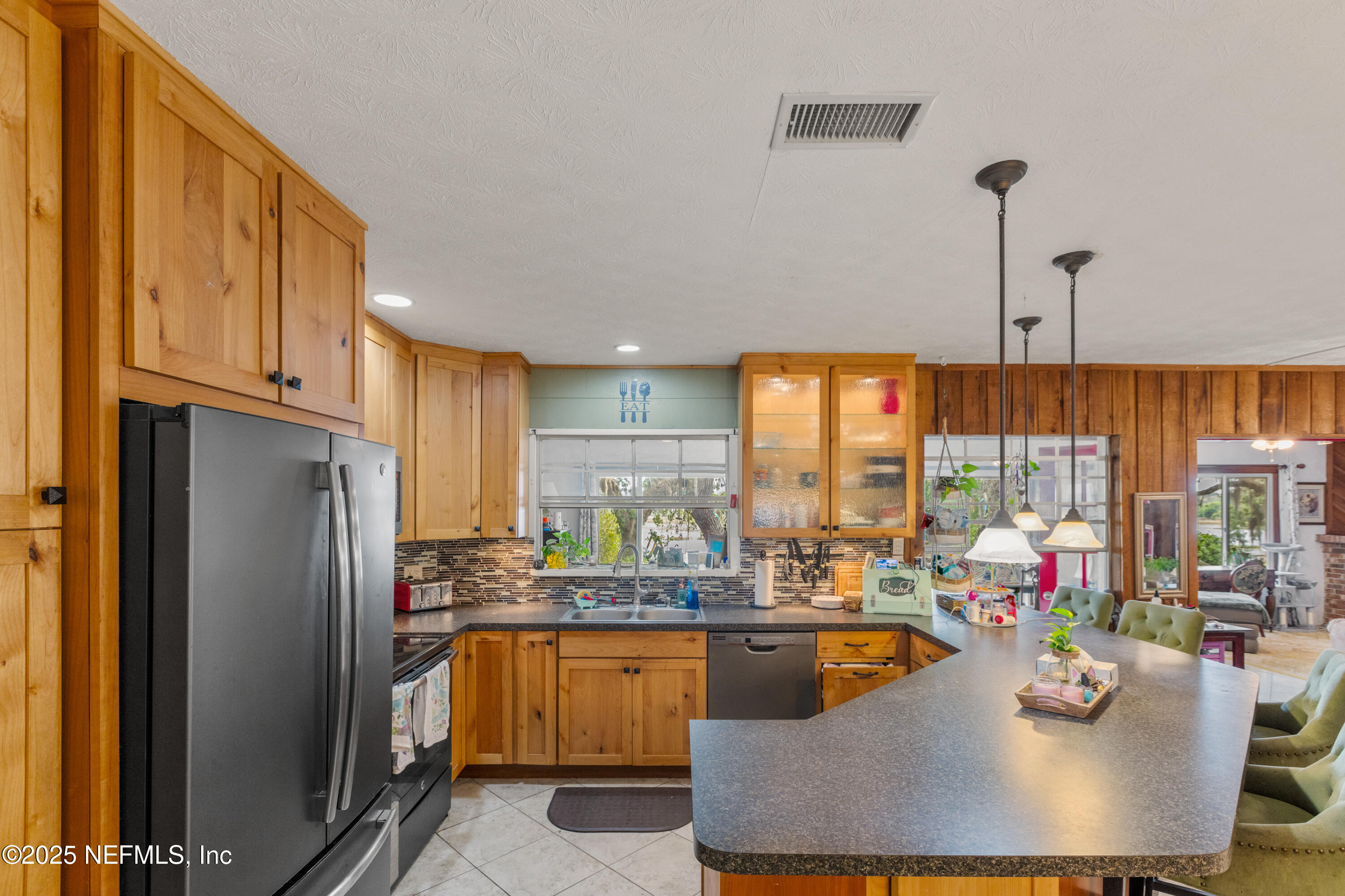 5915 White Sands Road Keystone Heights, FL 32656 - Photo 11 of 47 a kitchen with kitchen island granite countertop a sink counter top space and stainless steel appliances