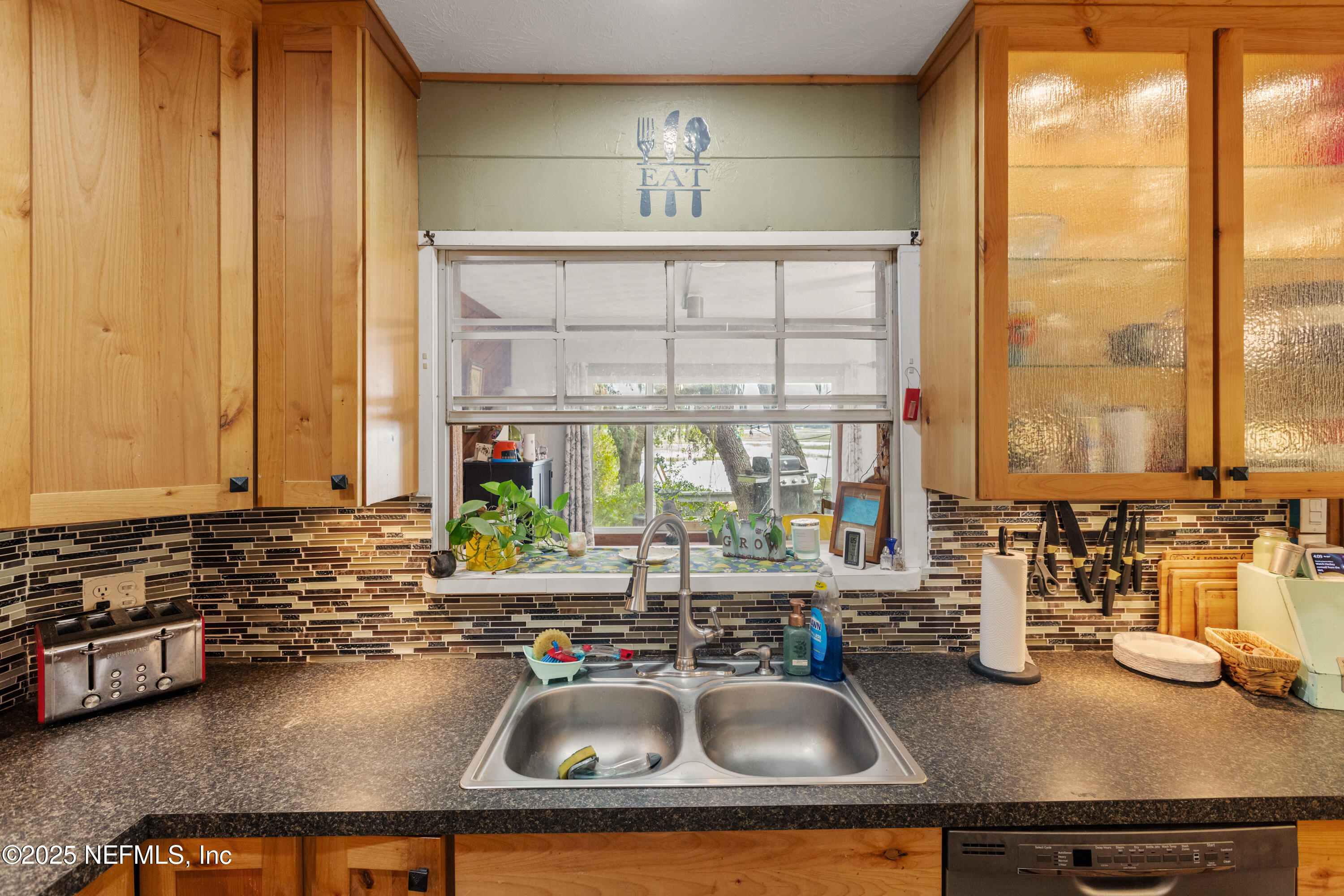 5915 White Sands Road Keystone Heights, FL 32656 - Photo 13 of 47 a kitchen with a sink a counter and a view of living room
