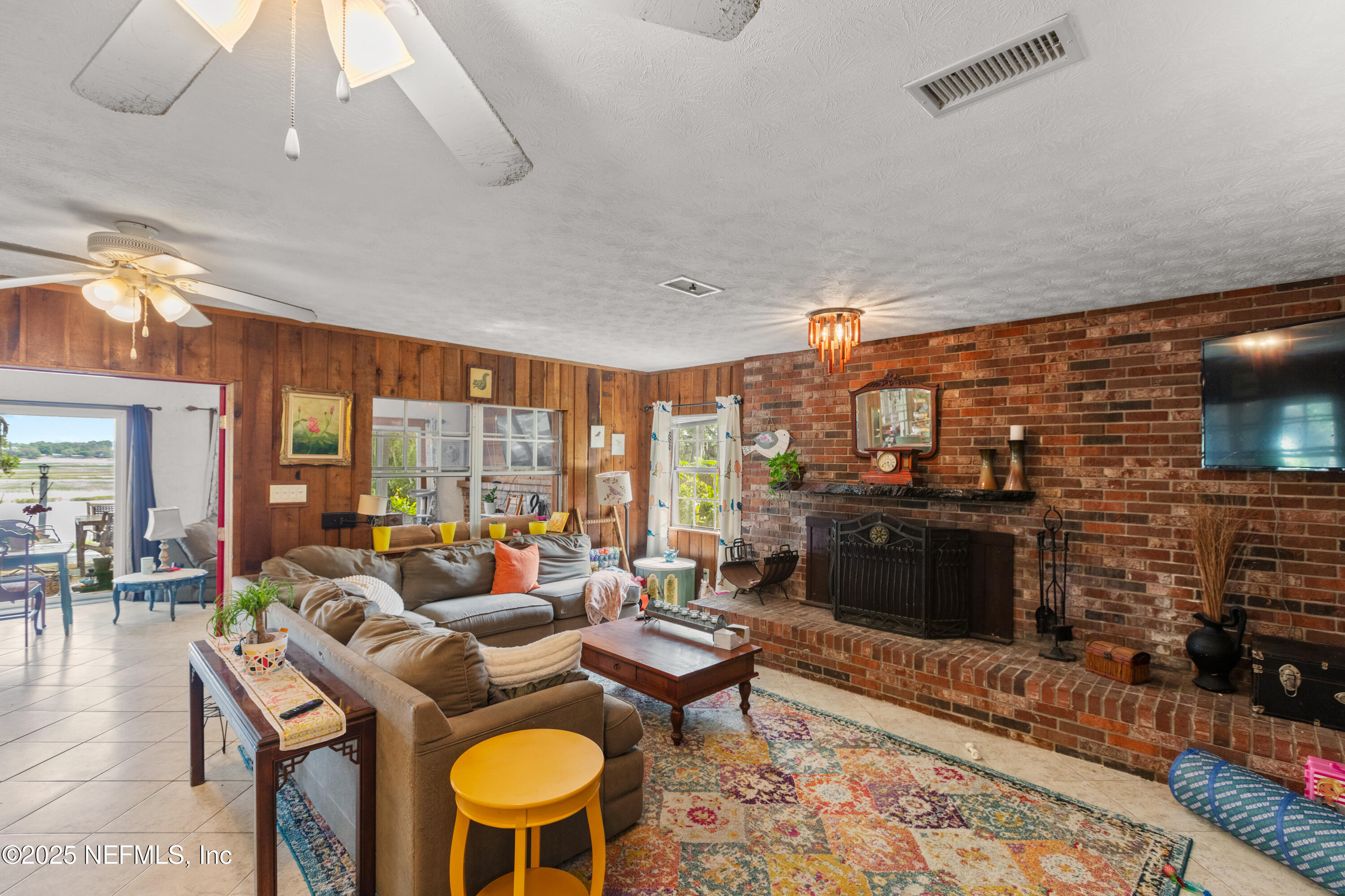 5915 White Sands Road Keystone Heights, FL 32656 - Photo 16 of 47 a living room with furniture a rug and a fireplace