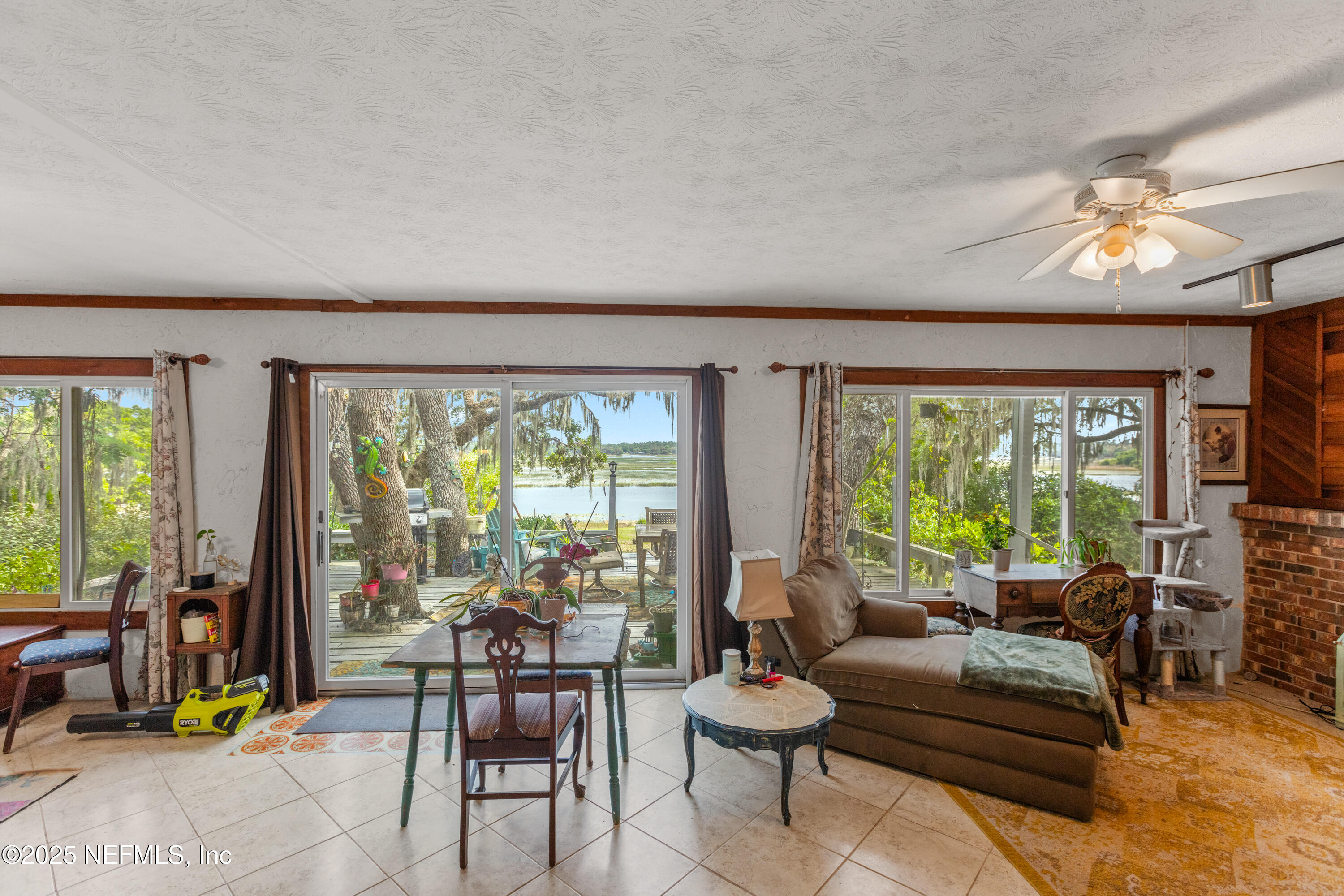 5915 White Sands Road Keystone Heights, FL 32656 - Photo 19 of 47 a living room with furniture and a floor to ceiling window