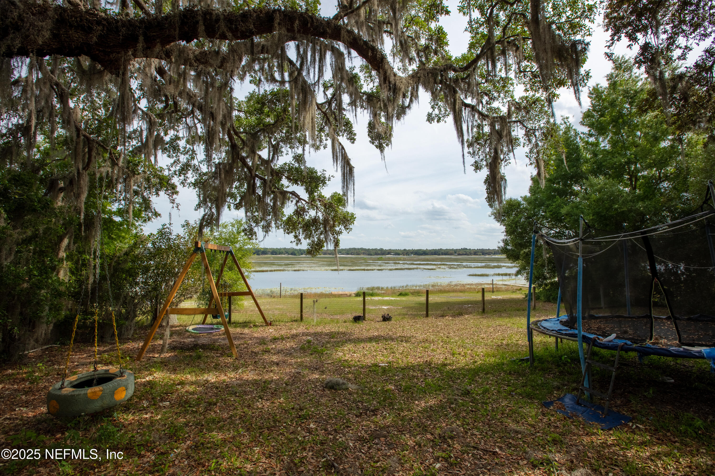5915 White Sands Road Keystone Heights, FL 32656 - Photo 36 of 47 a view of playground with a slide and swing