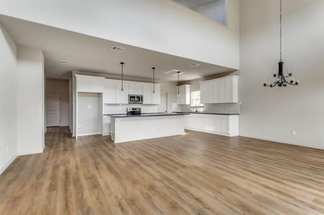 a view of a yard with trees in front of it