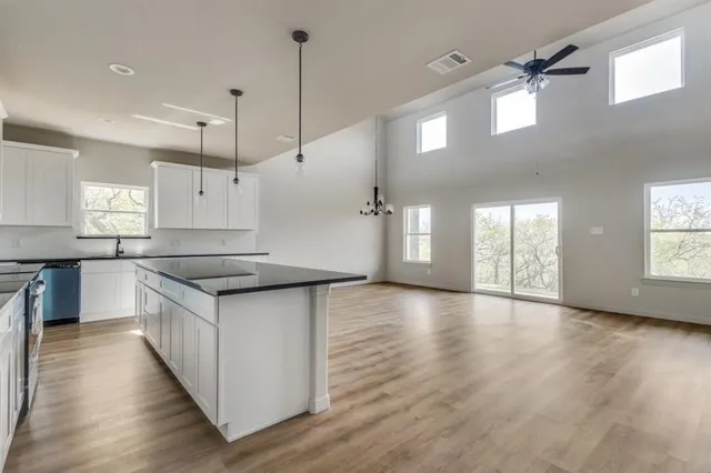 a view of kitchen with wooden floor and electronic appliances