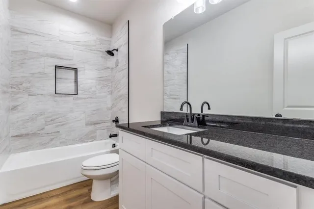 a bathroom with double sink and a mirror