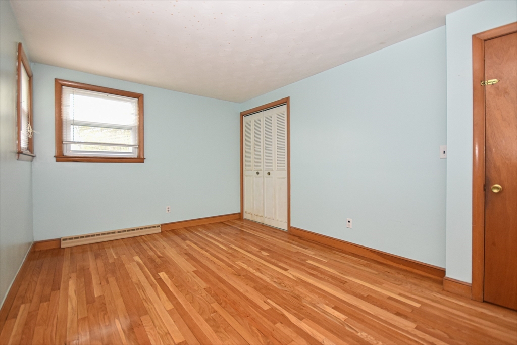 5 Brewster Road Randolph, MA 02368 - Photo 13 of 21 a view of an empty room with wooden floor and a window