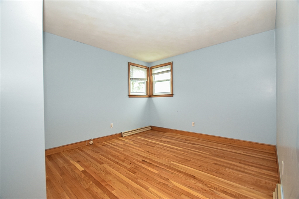 5 Brewster Road Randolph, MA 02368 - Photo 14 of 21 an empty room with wooden floor and windows