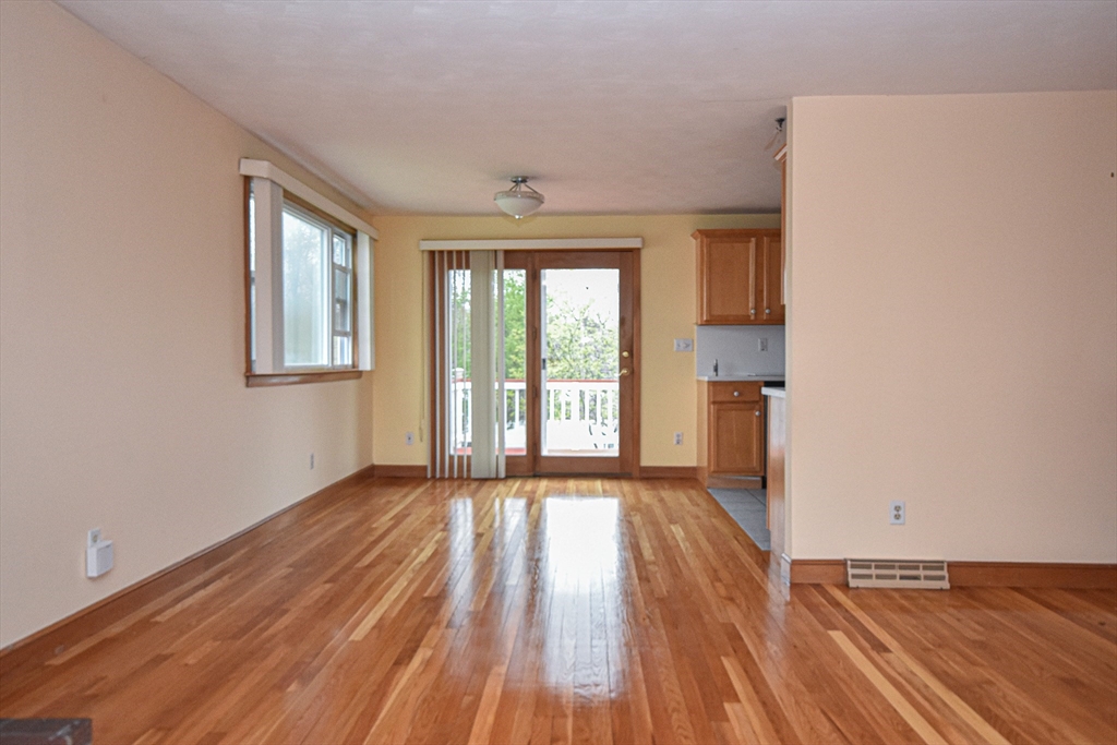 5 Brewster Road Randolph, MA 02368 - Photo 21 of 21 a view of an empty room with wooden floor and a window