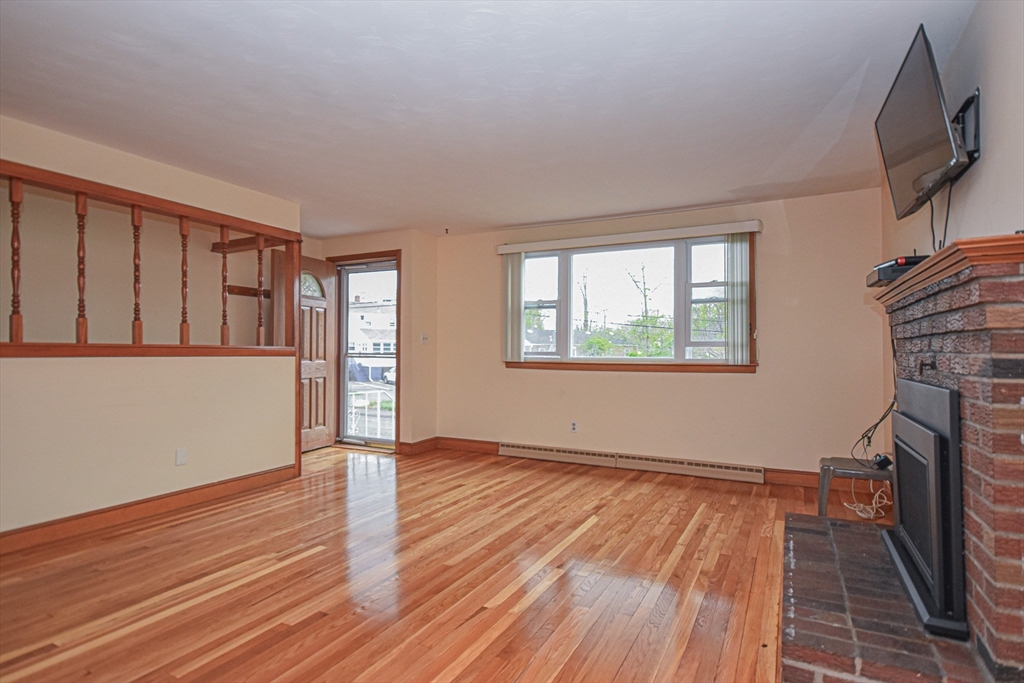 5 Brewster Road Randolph, MA 02368 - Photo 10 of 21 a view of an empty room with wooden floor and a window