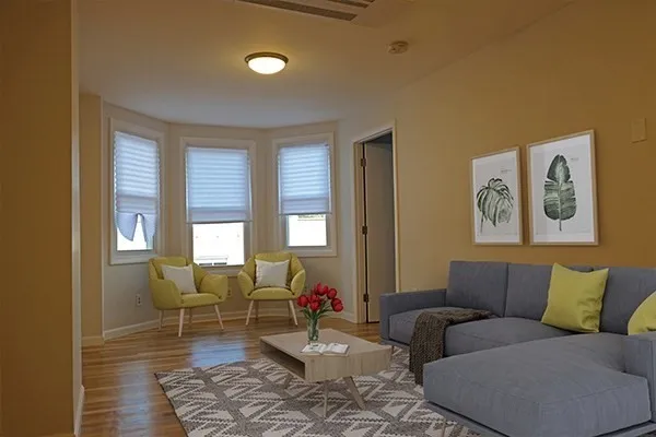 a living room with furniture and a large window