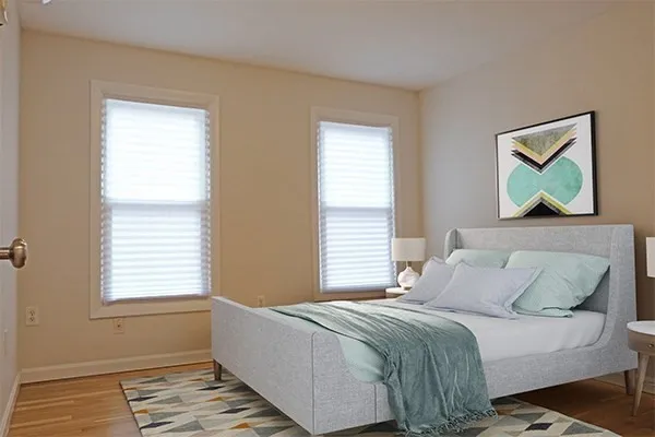 a bedroom with a bed and a window