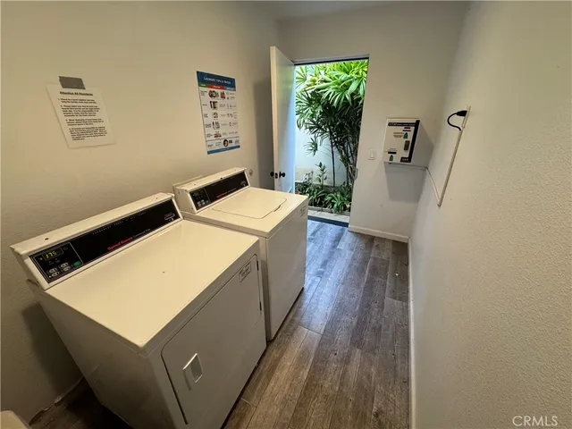 a room with wooden floor and a hallway