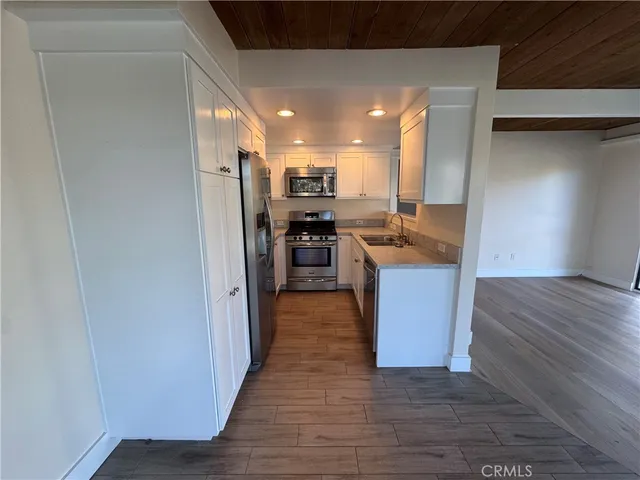 a kitchen with stainless steel appliances granite countertop a refrigerator and a sink