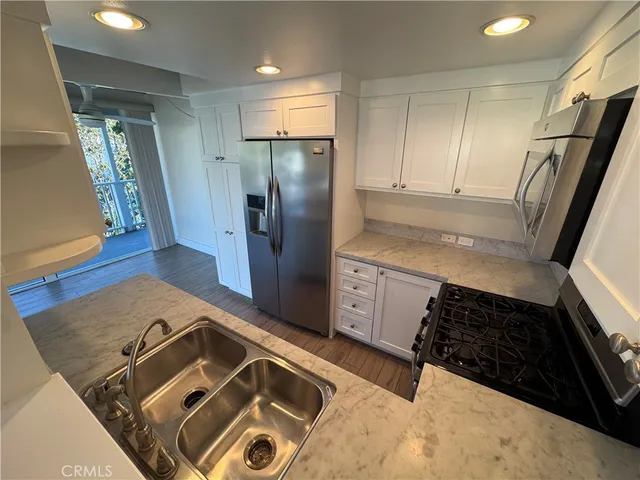 a kitchen with a refrigerator and a sink
