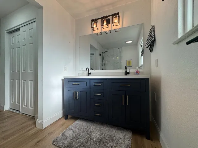 a bathroom with a sink vanity and a mirror