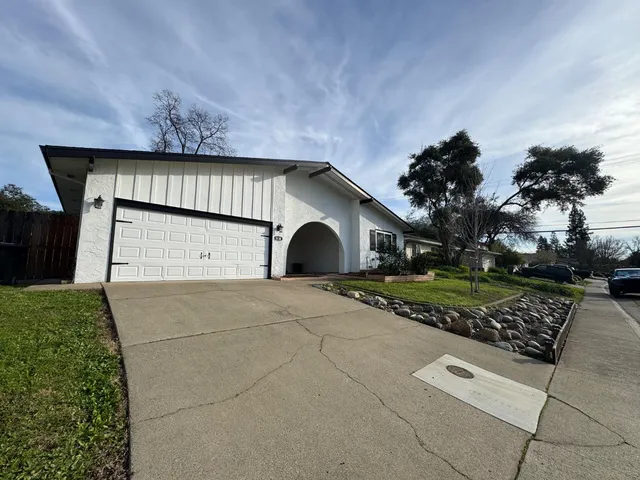 a front view of a house with a yard and garage