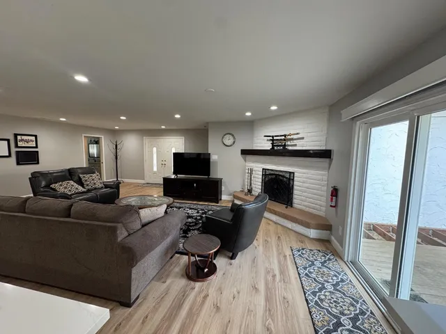 a living room with furniture and a fireplace