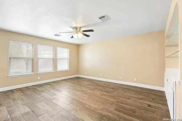 wooden floor in an empty room with a window