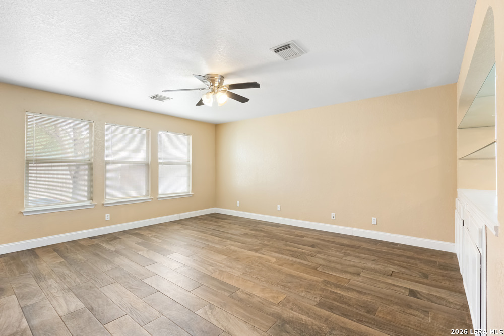 140 Springtree Parkway Cibolo, TX 78108 - Photo 12 of 25 wooden floor in an empty room with a window