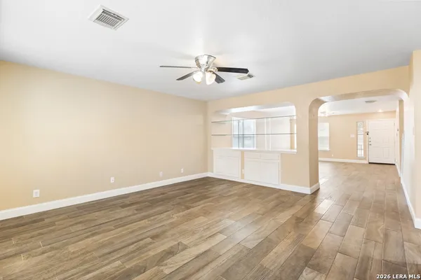 wooden floor in an empty room with a window