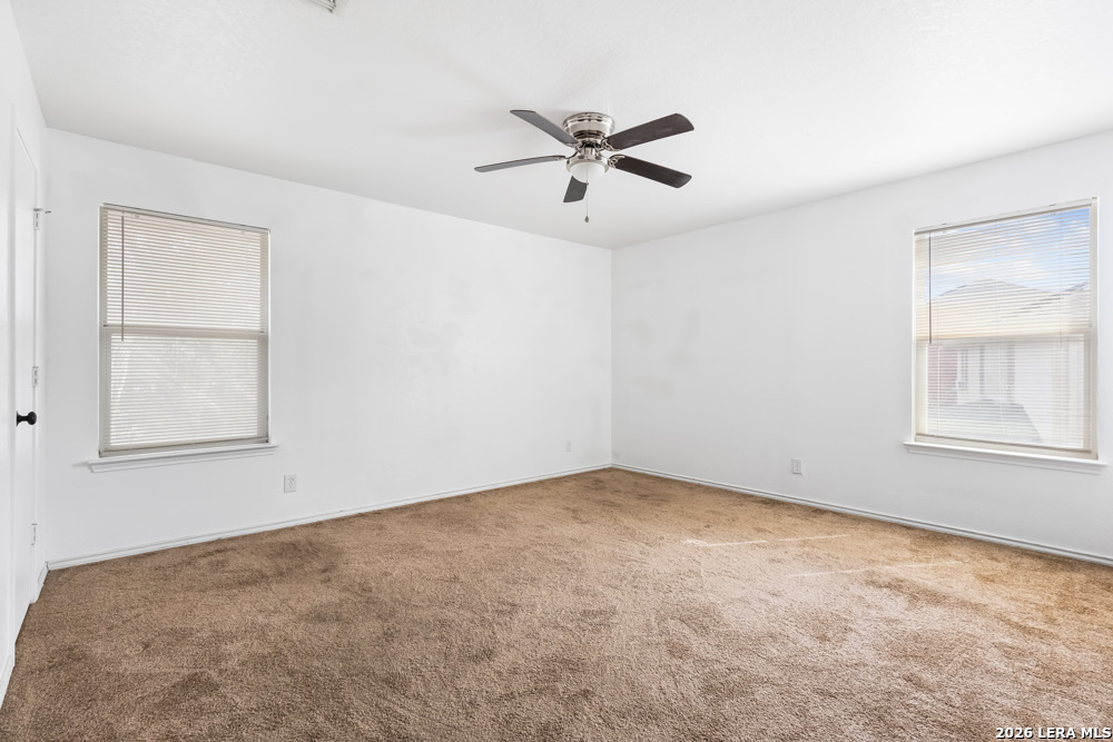 140 Springtree Parkway Cibolo, TX 78108 - Photo 20 of 25 an empty room with a window and a fan