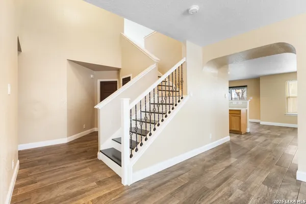 a view of entryway and hall with wooden floor
