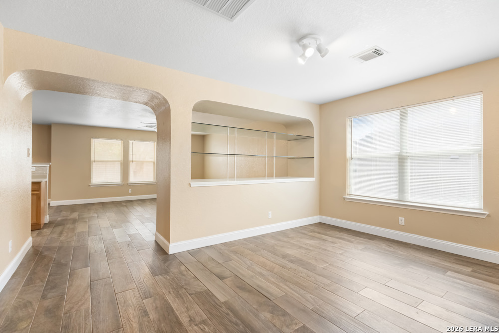 140 Springtree Parkway Cibolo, TX 78108 - Photo 6 of 25 a view of an empty room with wooden floor and a window