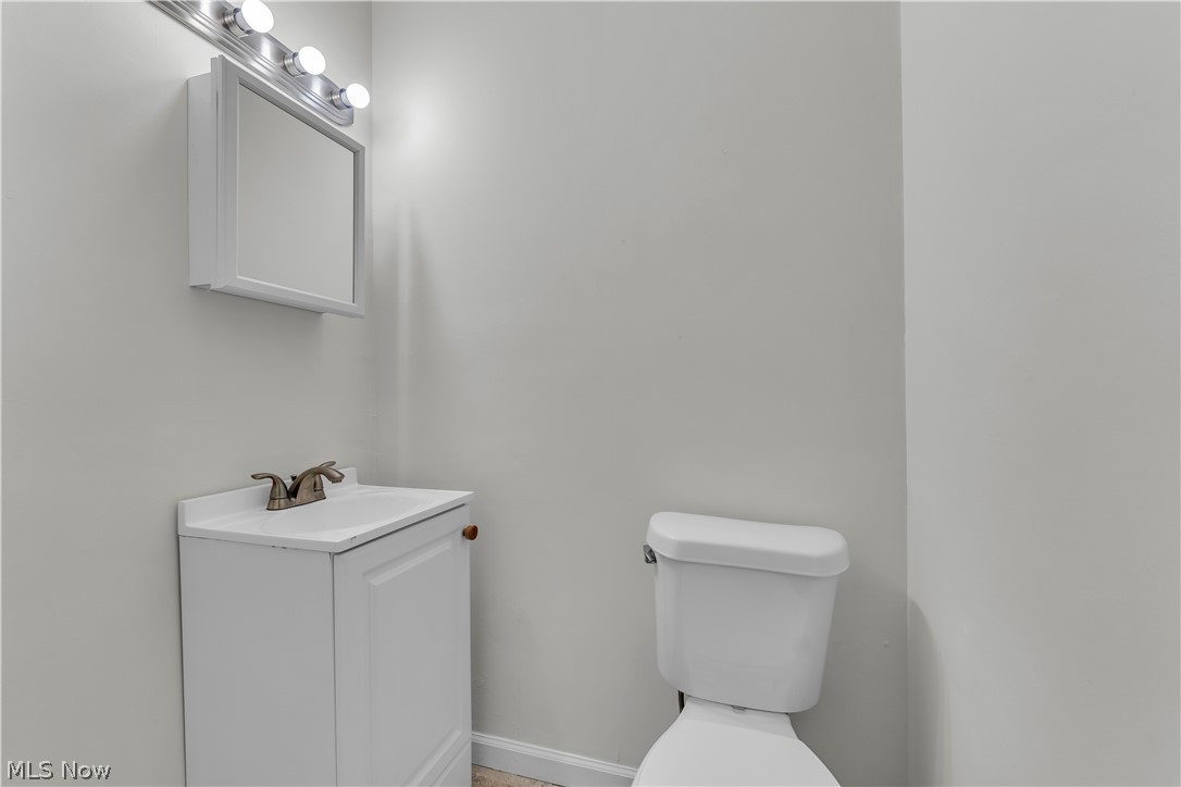 2540 Charney Road University Heights, OH 44118 - Photo 35 of 44 Bathroom featuring a white vanity with integrated sink, coordinating wall-mounted medicine cabinet, and a multi-bulb light fixture