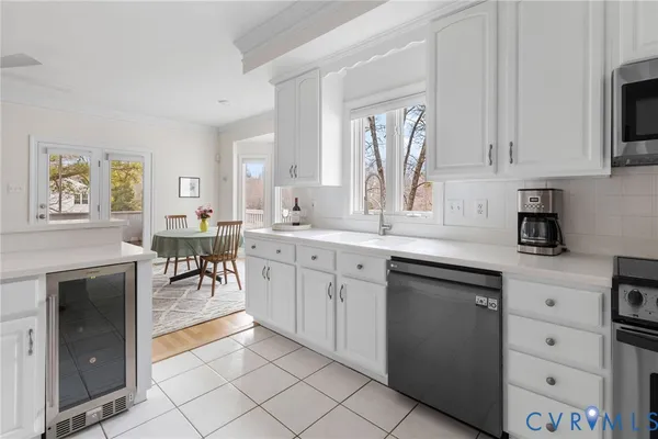a kitchen with cabinets and chairs