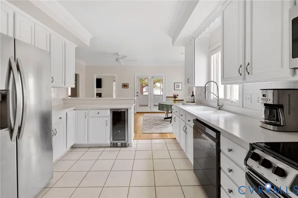 a kitchen with stainless steel appliances a sink stove and cabinets