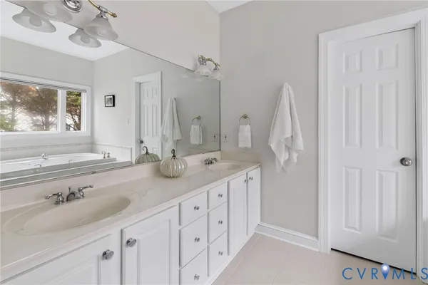 a bathroom with a tub shower and sink